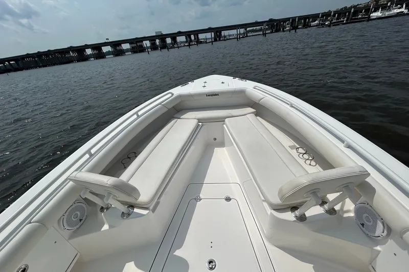 Slide: The Image of 2018 Everglades 273 Center Console boat with spacious seating, docked near a bridge. - 3