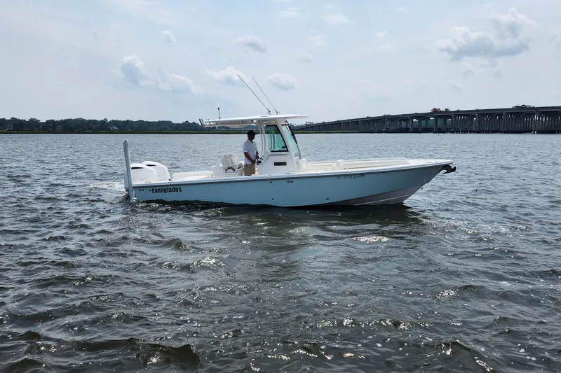 Slide: The Image of 2018 Everglades 273 Center Console boat on water, with bridge in background. - 14