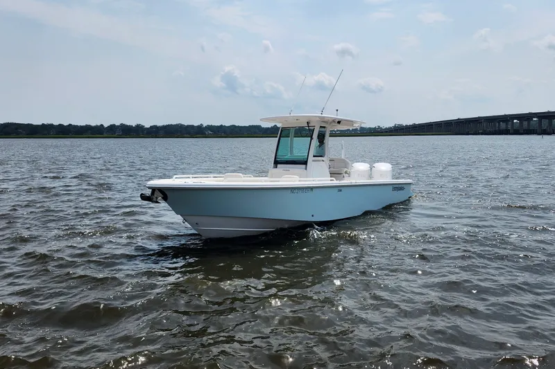 Slide: The Image of 2018 Everglades 273 Center Console boat on open water, near a bridge. - 9