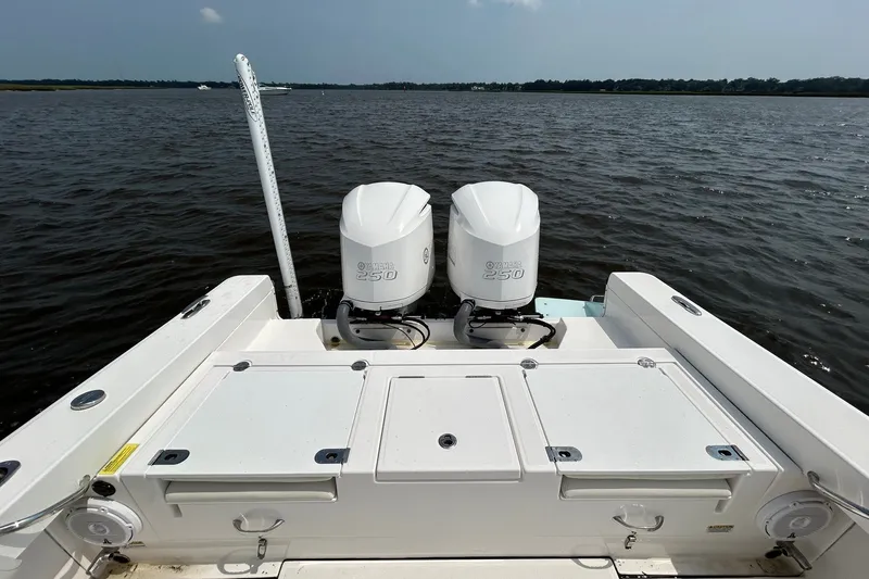 Slide: The Image of 2018 Everglades 273 Center Console boat with twin Yamaha 250 engines on water. - 6