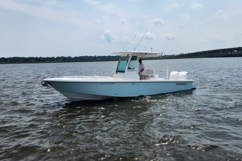 The Image of 2018 Everglades 273 Center Console boat on open water, clear sky background. - 0