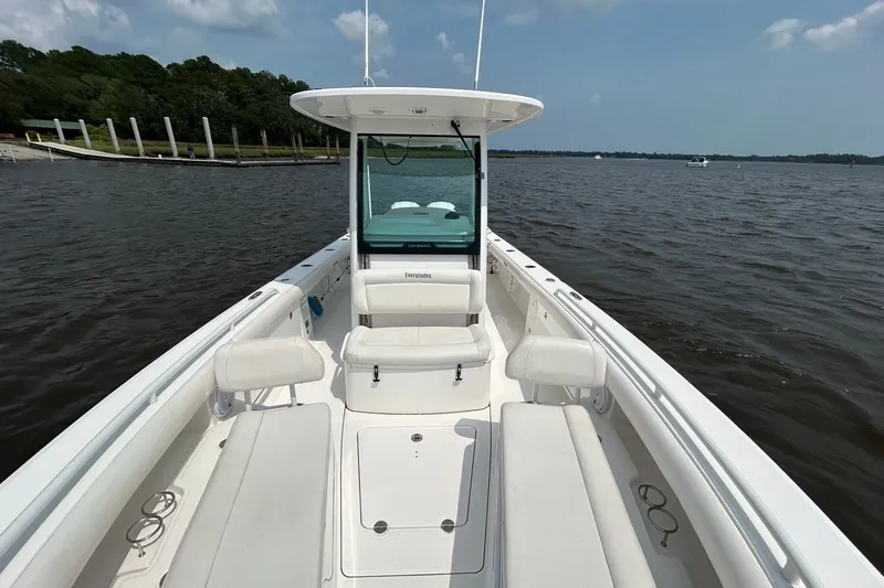 Slide: The Image of 2018 Everglades 273 Center Console boat on calm water, featuring spacious seating. - 4