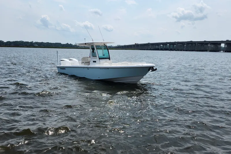 Slide: The Image of 2018 Everglades 273 Center Console boat on water near a bridge. - 13