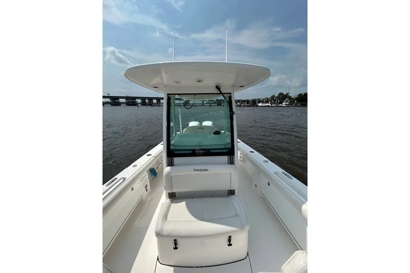 Slide: The Image of 2018 Everglades 273 Center Console boat on water, featuring sleek design and spacious seating. - 5