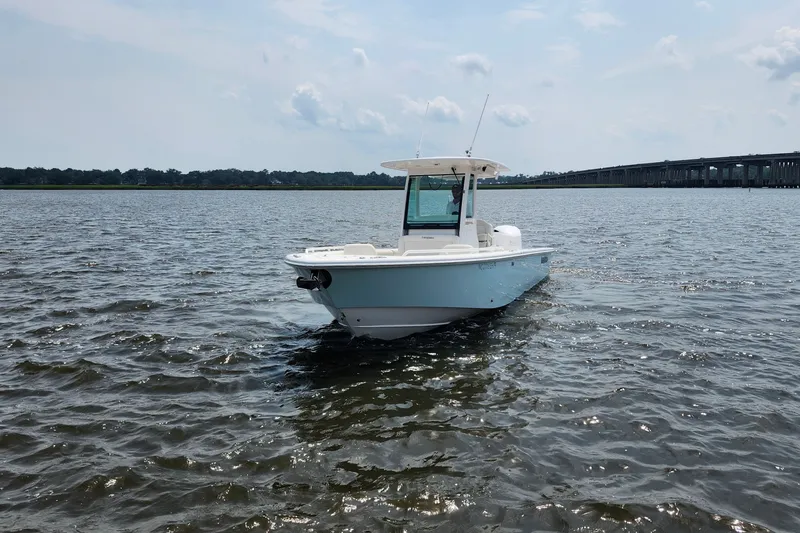Slide: The Image of 2018 Everglades 273 Center Console boat on open water, clear sky background. - 10