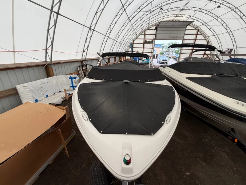 Slide: The Image of A 2017 Four Winns H180 SS boat in a covered storage area. - 5