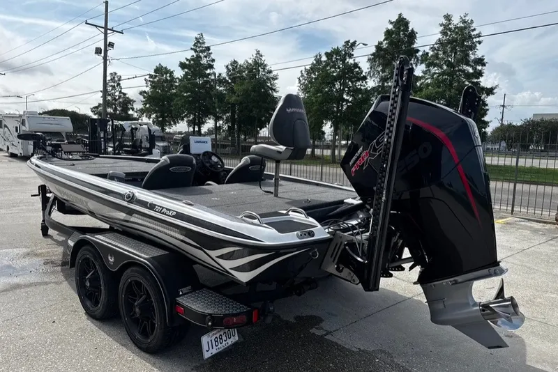 Slide: The Image of 2023 Phoenix 721 ProXP boat with powerful engine, parked outdoors on a trailer. - 2