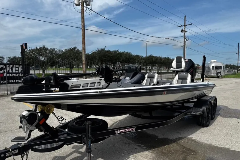 Slide: The Image of 2023 Phoenix 721 ProXP boat on trailer, parked outdoors under clear sky. - 3