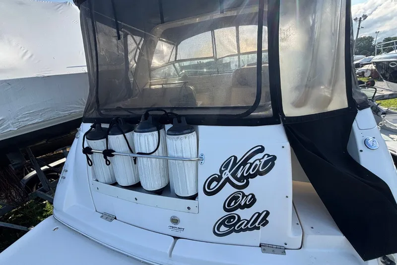 Slide: The Image of 2003 Rinker Fiesta Vee 312 boat with "Knot On Call" text on the stern. - 6