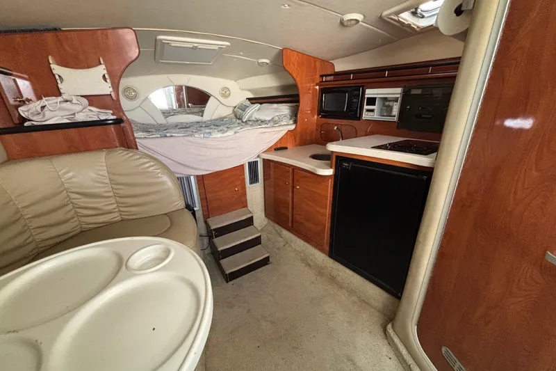 Slide: The Image of Interior of 2003 Rinker Fiesta Vee 312 boat with kitchenette and seating area. - 31