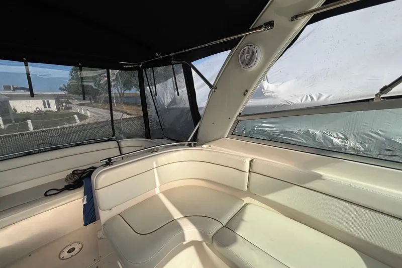 Slide: The Image of Interior of a 2003 Rinker Fiesta Vee 312 boat with beige seating and windows. - 10