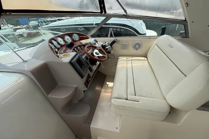 Slide: The Image of Cockpit of 2003 Rinker Fiesta Vee 312 with steering wheel and gauges. - 15