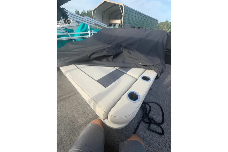 Slide: The Image of 2024 Barletta A22UC boat interior with cushioned seating and cup holders. - 20