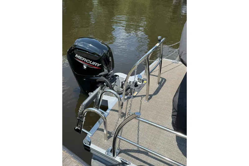 Slide: The Image of 2024 Barletta A22UC pontoon boat with Mercury outboard motor on water. - 12