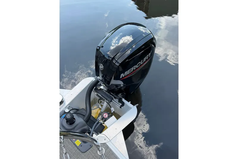 Slide: The Image of 2024 Barletta A22UC boat with Mercury outboard motor on calm water. - 13