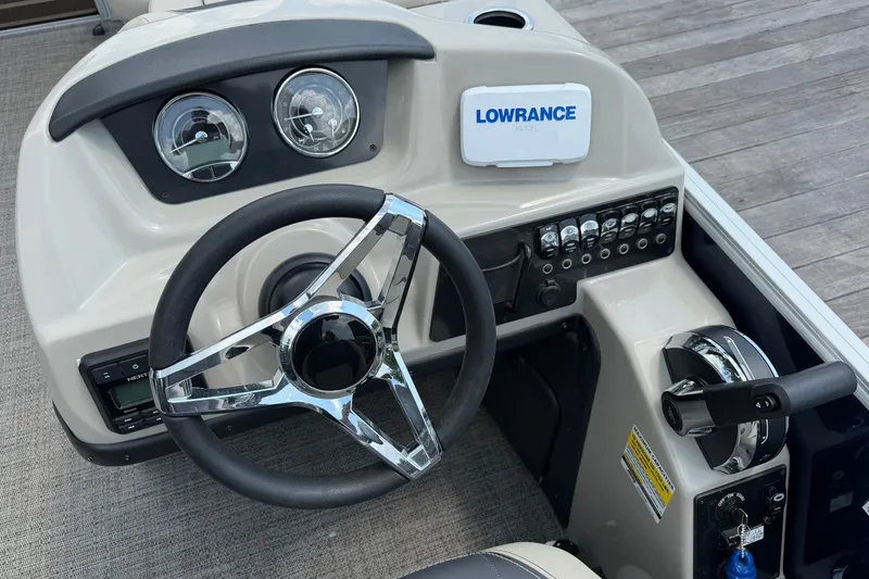 Slide: The Image of 2024 Barletta A22UC boat dashboard with steering wheel and Lowrance navigation system. - 9