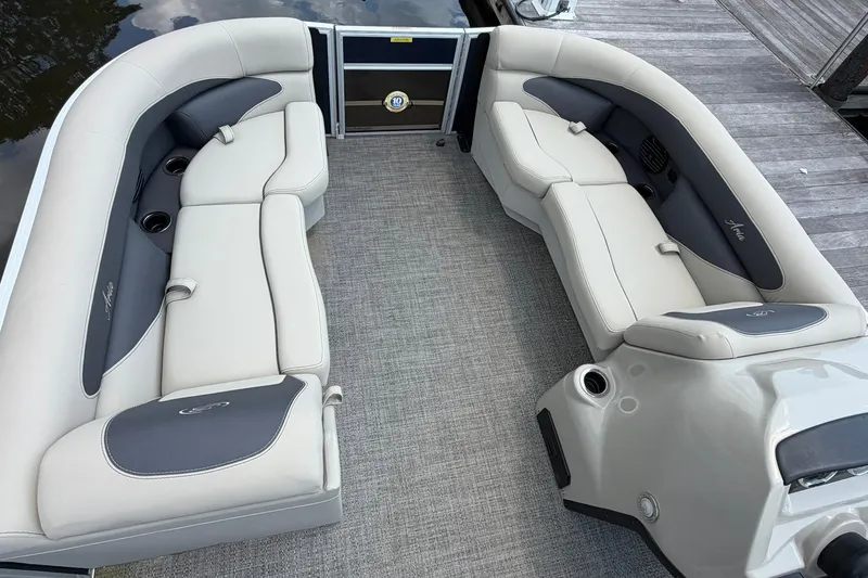 Slide: The Image of 2024 Barletta A22UC pontoon boat interior with plush seating and cup holders. - 6
