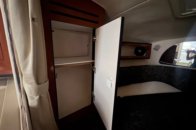 Slide: The Image of Interior view of 2004 Sea Ray Sundancer 280 cabin with open storage compartment. - 16