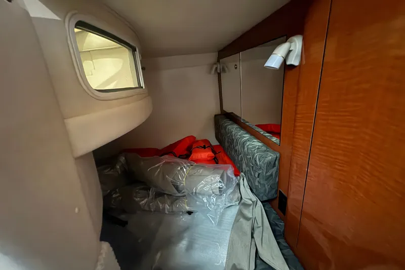 Slide: The Image of Interior cabin of 2004 Sea Ray Sundancer 280 with wood paneling and window. - 18