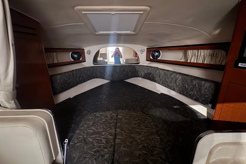 Slide: The Image of 2004 Sea Ray Sundancer 280 cabin interior with cozy seating and elegant wood accents. - 17