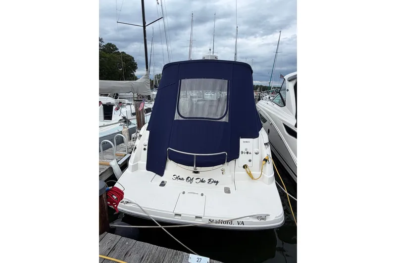 Slide: The Image of 2008 Monterey 330 Sport Yacht docked, featuring a navy blue cover and "Hair Of The Dog" name. - 2
