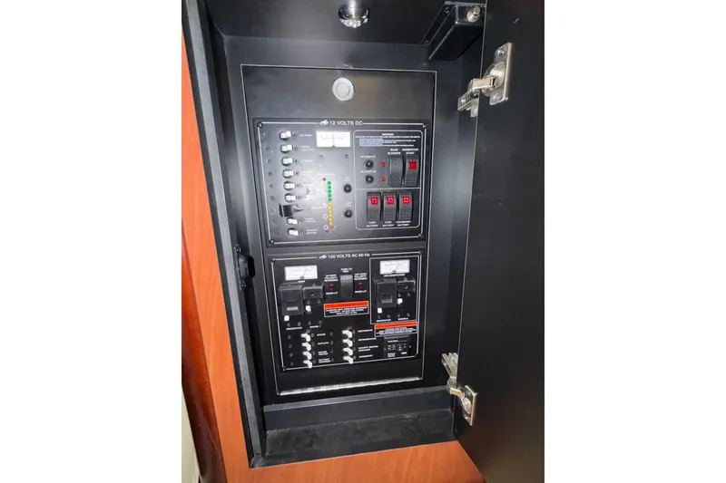 Slide: The Image of Electrical panel inside a 2008 Monterey 330 Sport Yacht, showcasing switches and circuit breakers. - 34