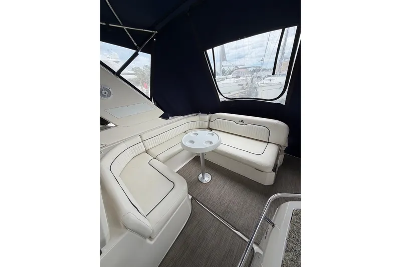 Slide: The Image of Interior of 2008 Monterey 330 Sport Yacht with white seating and small table. - 12