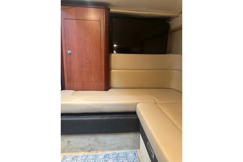 Slide: The Image of Interior of 2008 Monterey 330 Sport Yacht with beige seating and wooden cabinet. - 27