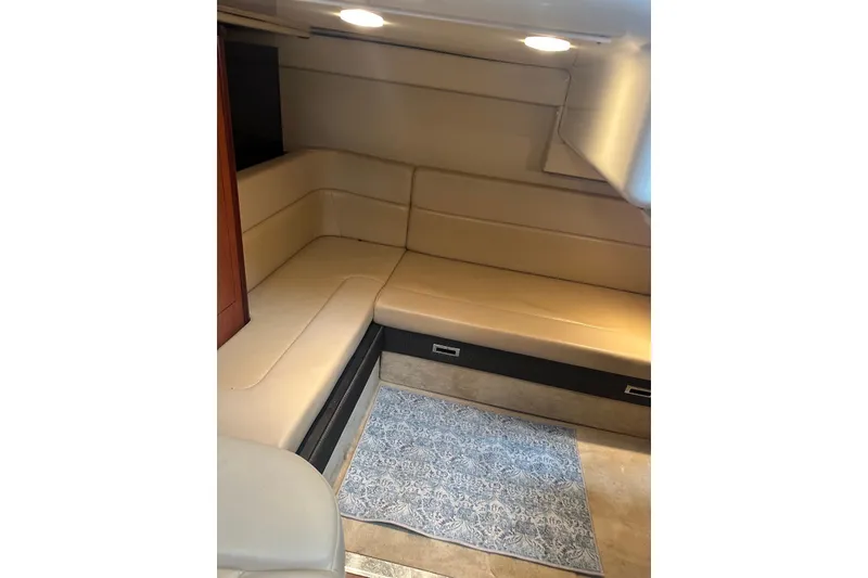 Slide: The Image of Interior of 2008 Monterey 330 Sport Yacht with beige seating and patterned rug. - 28