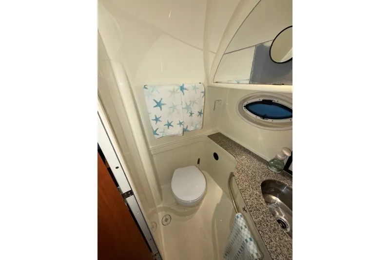 Slide: The Image of Bathroom interior of 2008 Monterey 330 Sport Yacht with starfish decor and porthole window. - 35