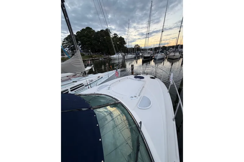 Slide: The Image of 2008 Monterey 330 Sport Yacht docked at marina during sunset, surrounded by sailboats. - 6