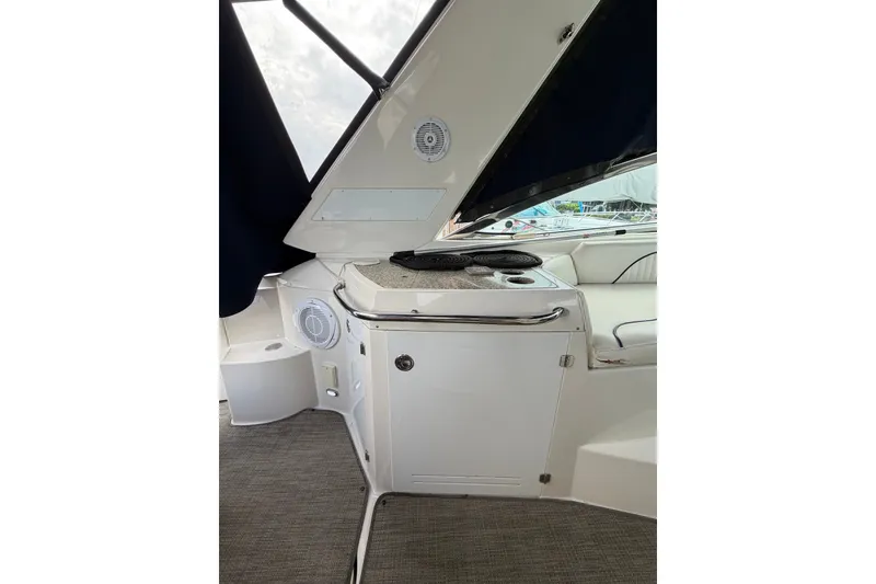Slide: The Image of 2008 Monterey 330 Sport Yacht interior with kitchenette and seating area. - 19