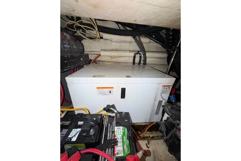 Slide: The Image of Engine compartment of a 2008 Monterey 330 Sport Yacht with batteries and wiring. - 45