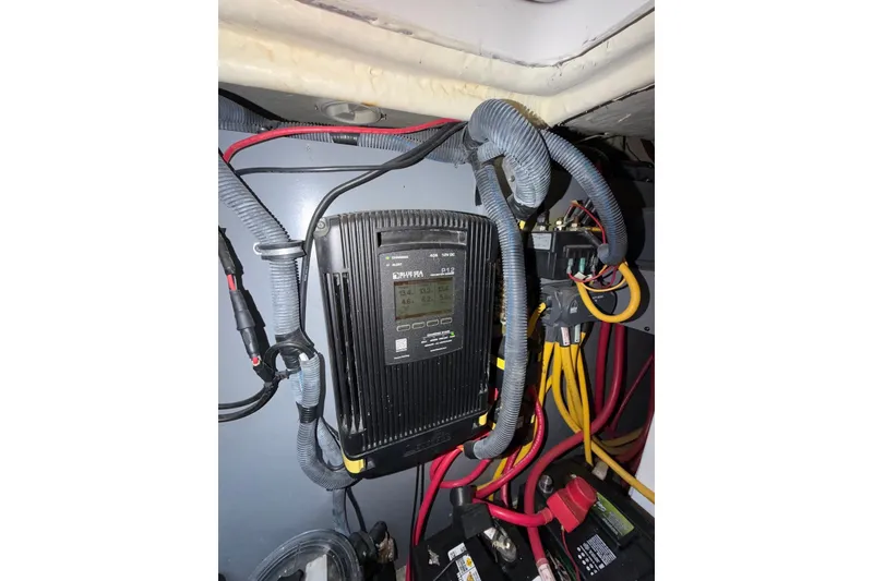Slide: The Image of Electrical system inside a 2008 Monterey 330 Sport Yacht, featuring cables and a control panel. - 37