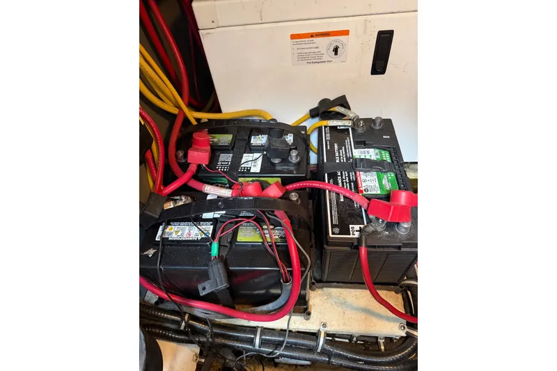 Slide: The Image of Battery compartment of a 2008 Monterey 330 Sport Yacht with connected cables. - 39