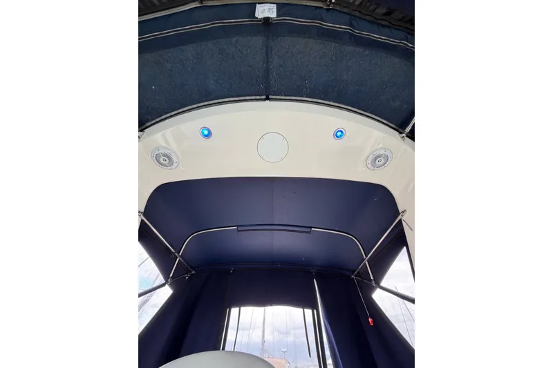 Slide: The Image of Interior view of 2008 Monterey 330 Sport Yacht with blue canopy and ceiling speakers. - 20