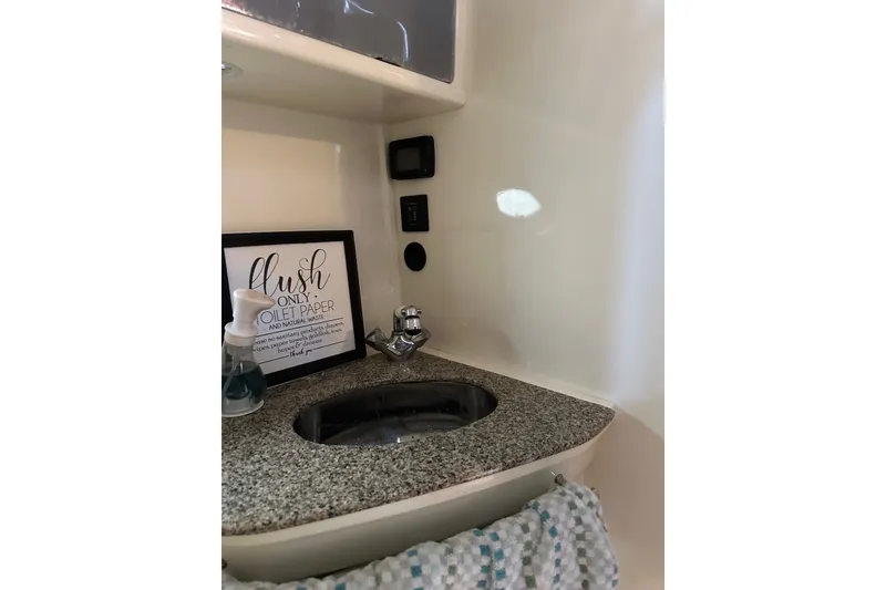 Slide: The Image of 2008 Monterey 330 Sport Yacht bathroom sink with granite countertop and decor. - 23