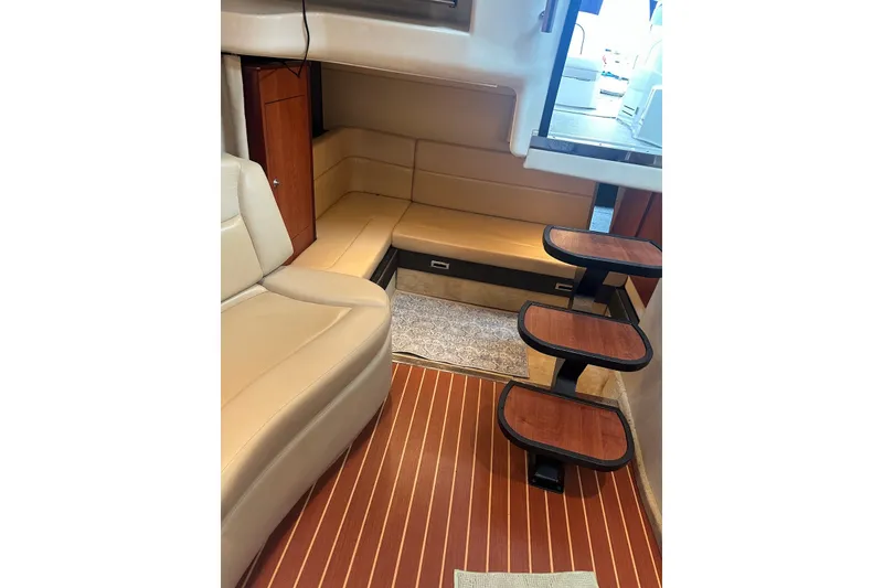 Slide: The Image of Interior of 2008 Monterey 330 Sport Yacht with beige seating and wooden steps. - 29