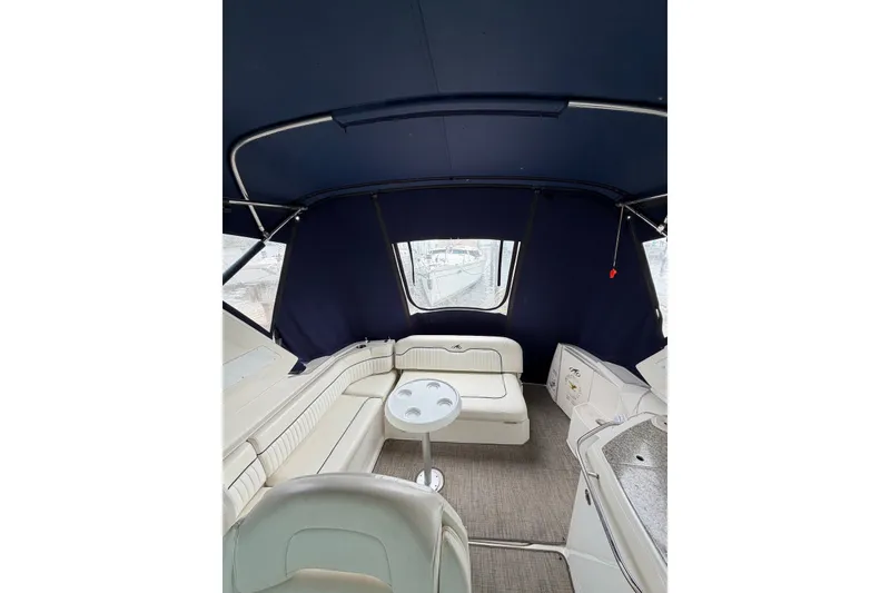 Slide: The Image of Interior of 2008 Monterey 330 Sport Yacht with seating and table under blue canopy. - 11
