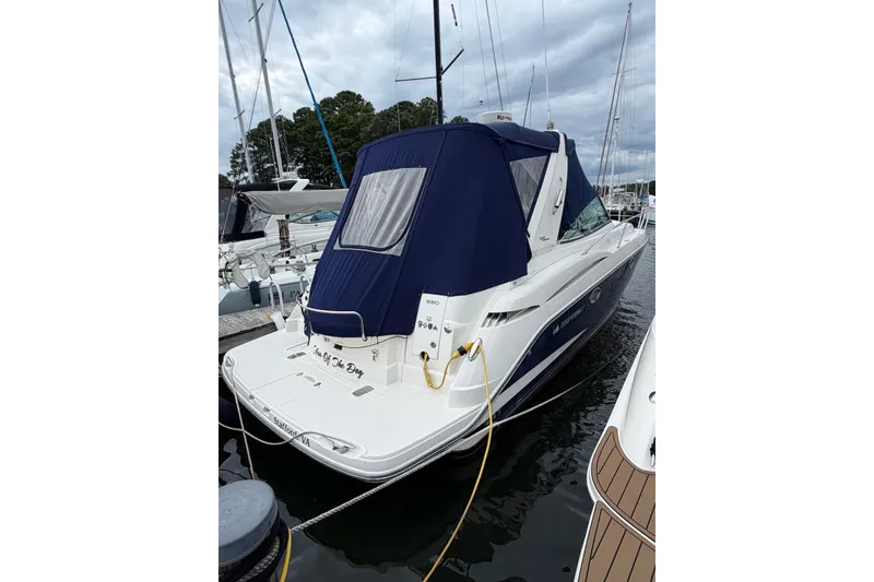 Slide: The Image of 2008 Monterey 330 Sport Yacht docked with blue canopy, rear view. - 3
