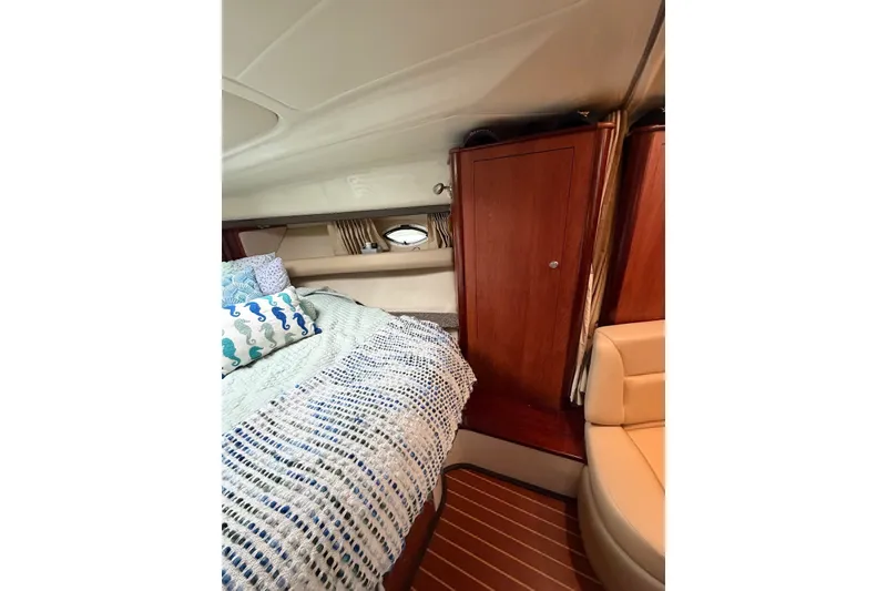 Slide: The Image of Interior cabin of 2008 Monterey 330 Sport Yacht with bed and wooden cabinetry. - 31