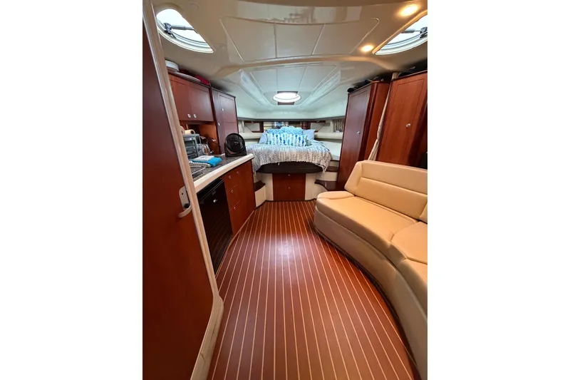 Slide: The Image of Interior of 2008 Monterey 330 Sport Yacht with wood flooring and cozy seating area. - 22