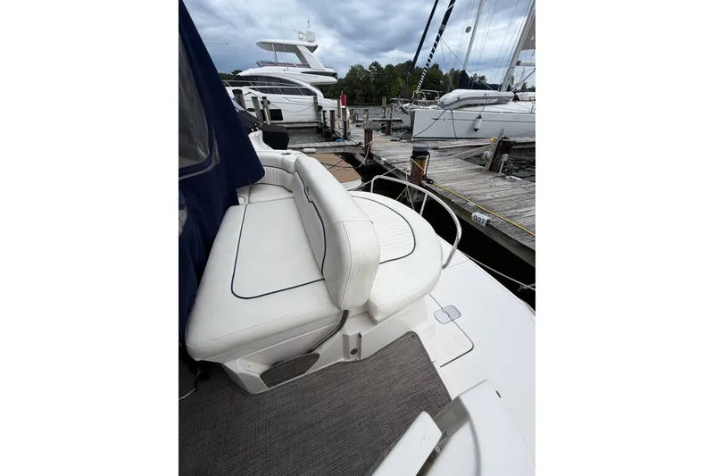 Slide: The Image of 2008 Monterey 330 Sport Yacht docked, featuring white seating and marina view. - 14
