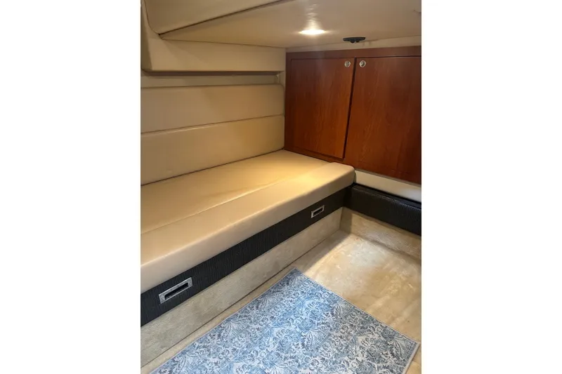 Slide: The Image of Interior cabin of 2008 Monterey 330 Sport Yacht with beige seating and wooden cabinets. - 26