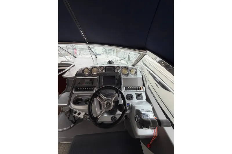 Slide: The Image of Cockpit of 2008 Monterey 330 Sport Yacht with steering wheel and control panel. - 16