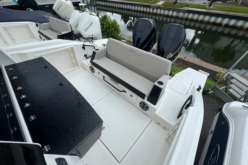 Slide: The Image of 2026 Navan C30 boat interior with seating, storage, and Mercury outboard engines by a canal. - 25