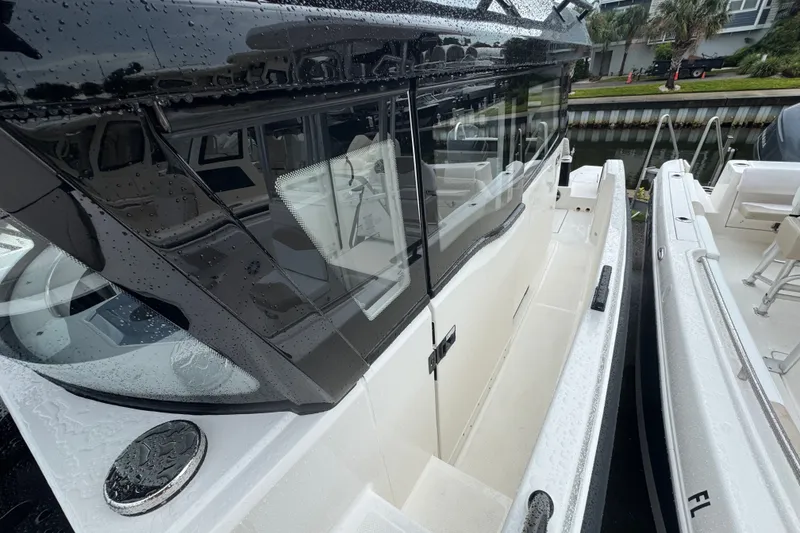 Slide: The Image of 2026 Navan C30 boat with sleek design, wet deck, and modern features docked by the canal. - 14