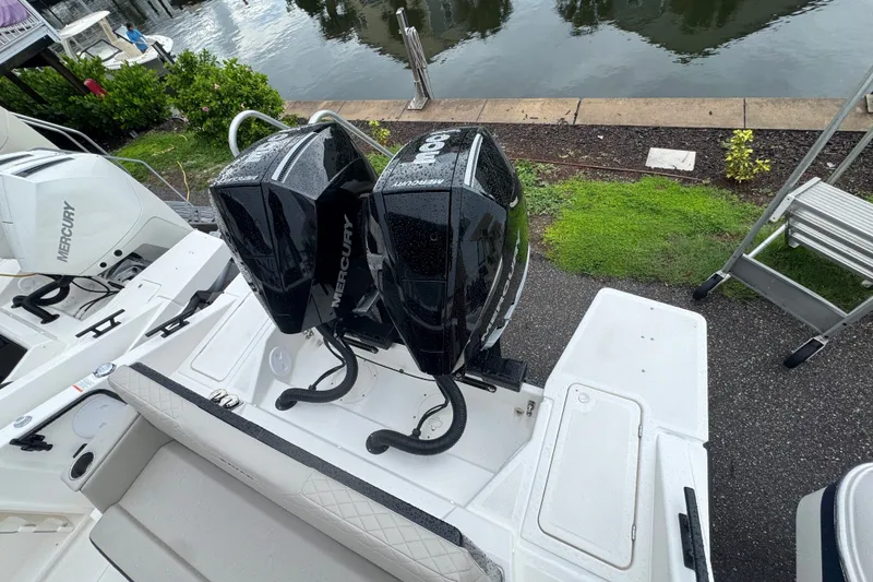 Slide: The Image of Navan C30 2026 boat with dual Mercury outboard engines docked by the water. - 26