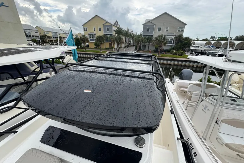 Slide: The Image of 2026 Navan C30 boat with sleek design, docked near waterfront homes. - 13
