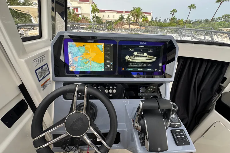 Slide: The Image of 2026 Navan C30 boat dashboard with dual Simrad displays and navigation controls. - 16
